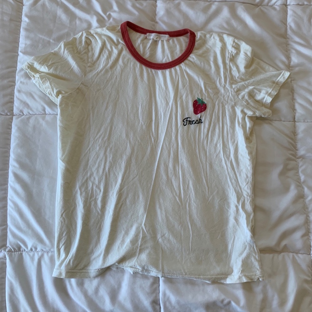 creme tee with strawberry on front and red collar